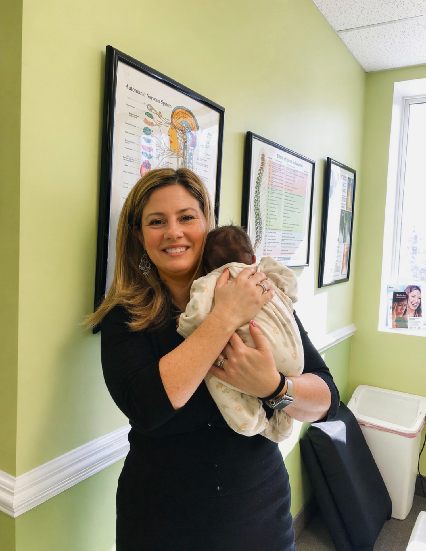 Dr. Michelle Herczeg holding a newborn at Severna Park Family Chiropractic